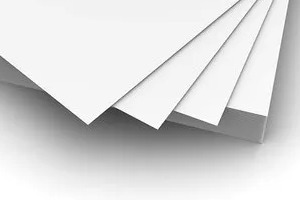 A stack of white and grey duplex paper board sheets.