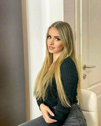 Chanel Cazzaniga, a very beautiful blonde woman with a radiant smile sitting c