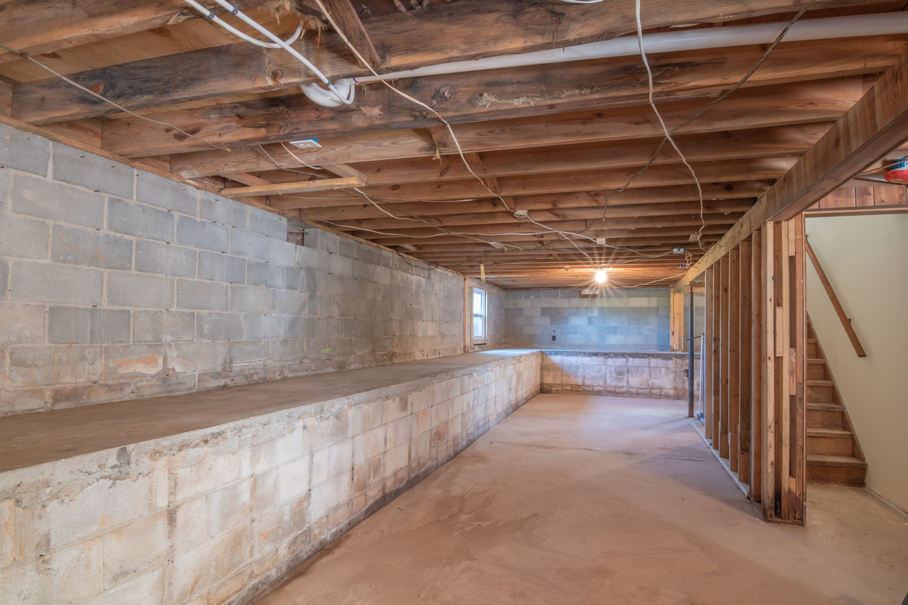 Water damage restoration technician inspecting an older Allouez Wisconsin home