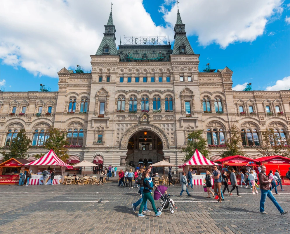 Front exterior of GUM Department Store in Moscow with glass roof and arched entrance.