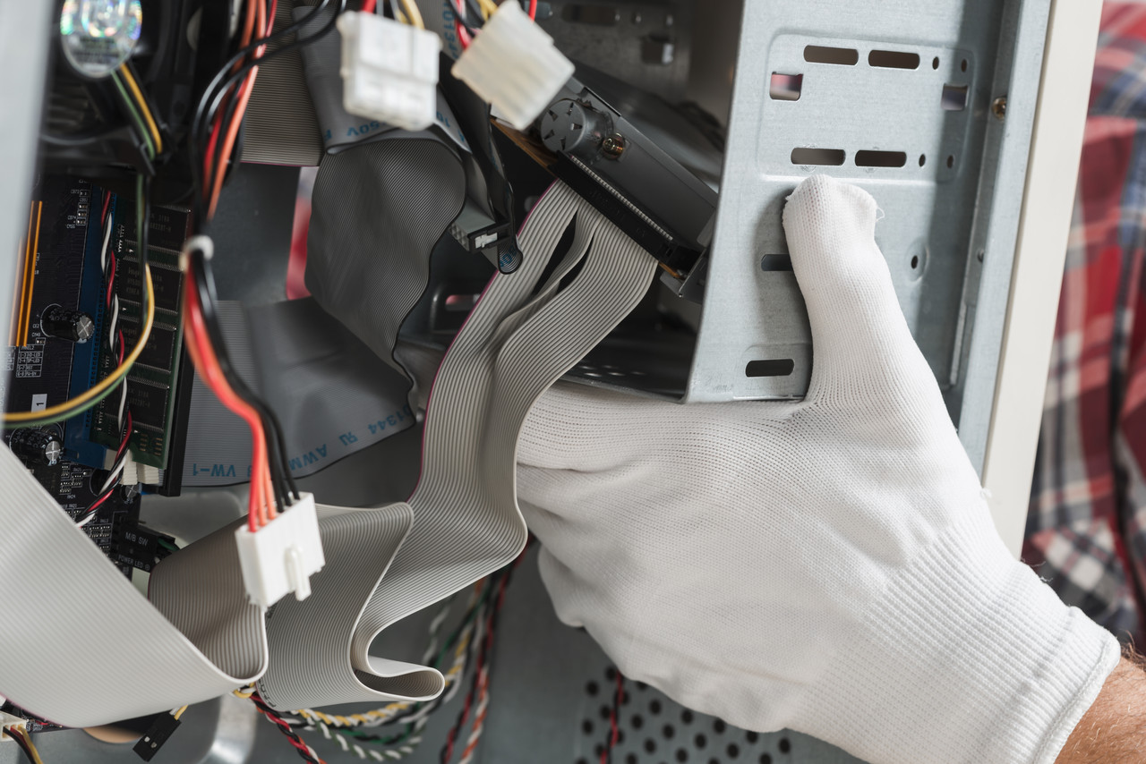 technician hand with gloves repairing computer