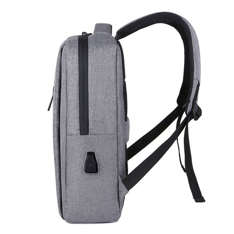 2026 hot-selling custom slim business laptop backpack with USB charging port placed on luggage case, featured as best B2B corporate gift choice