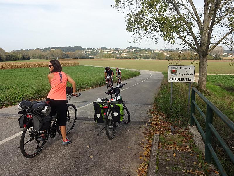 Cyclists riding along on a beautiful small rural road near Aveiro, Portugal