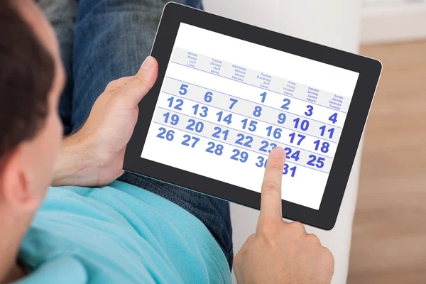 depositphotos-46204015-stock-photo-man-using-calendar-on-digital.webp