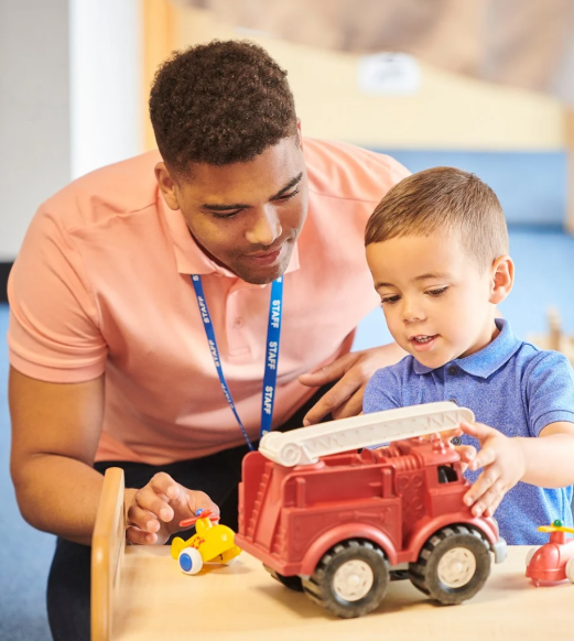 A teacher sharing a child's day with a parent at pickup