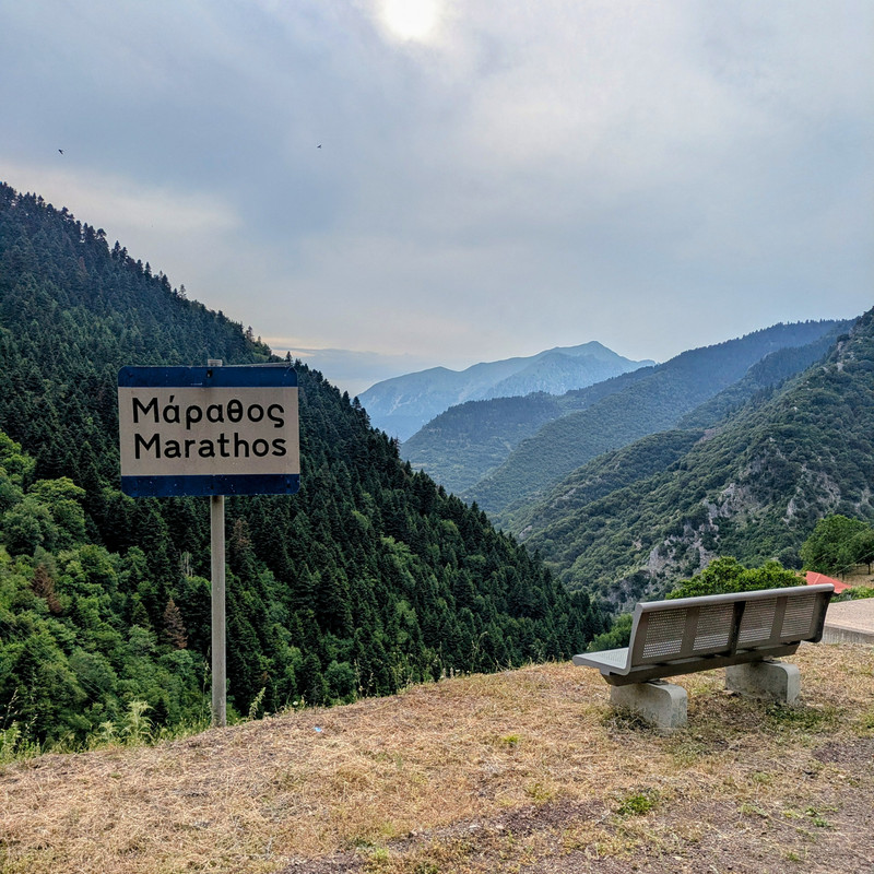 A bench near a cliff with a view of the mountains