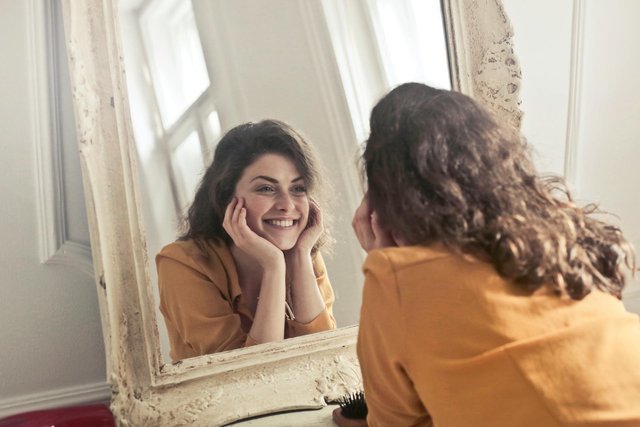 self reflection of a happy woman