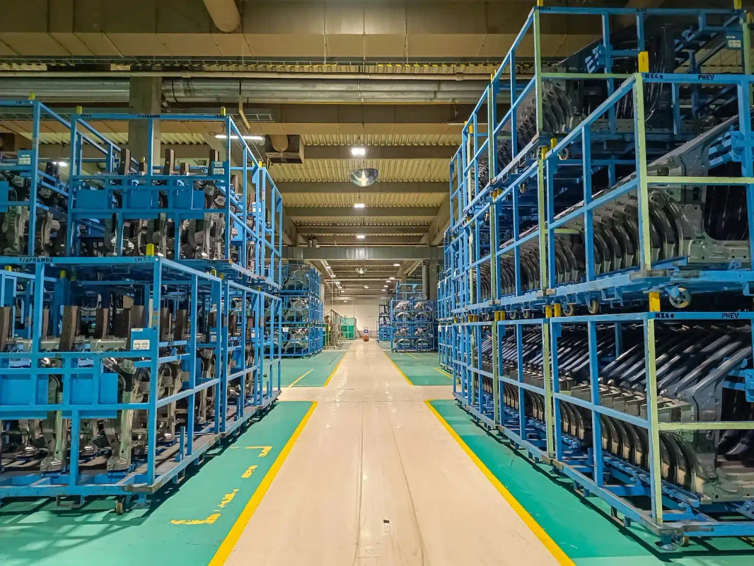 Pallets with automotive parts stored in a factory warehouse