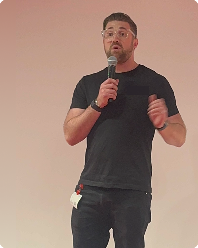 James Ferguson speaking on stage about performance and burnout