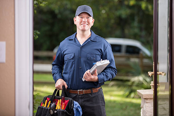 Bright Edge PC Works pest control technician performing a treatment at a home exterior