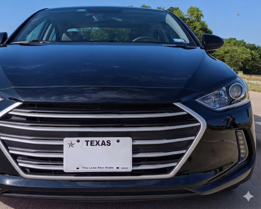 Front view of a car with a properly mounted Texas front license plate on the bumper