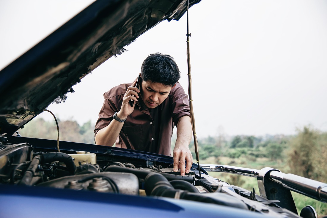man-try-fix-car-engine-problem-local-road (1)