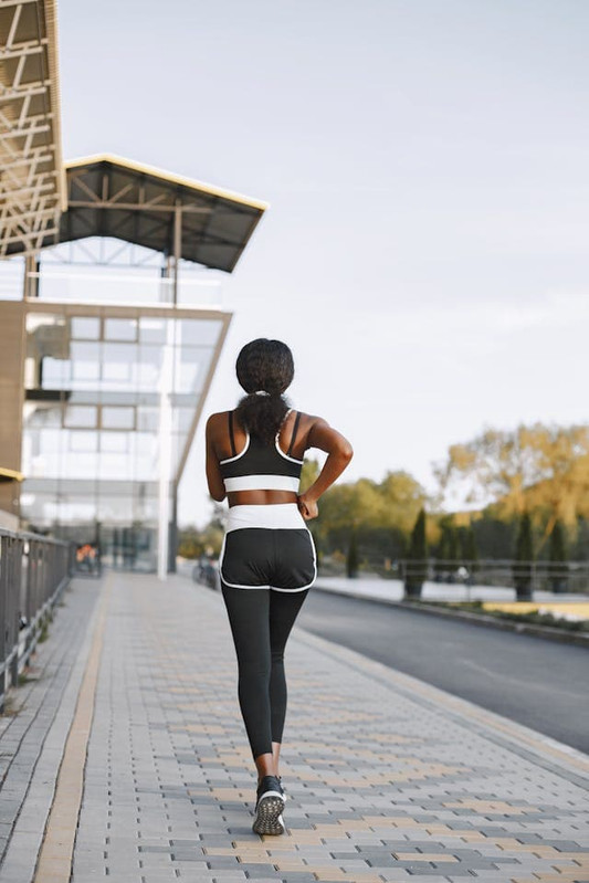 a girl walking on road to keep herself active and her gut healthy