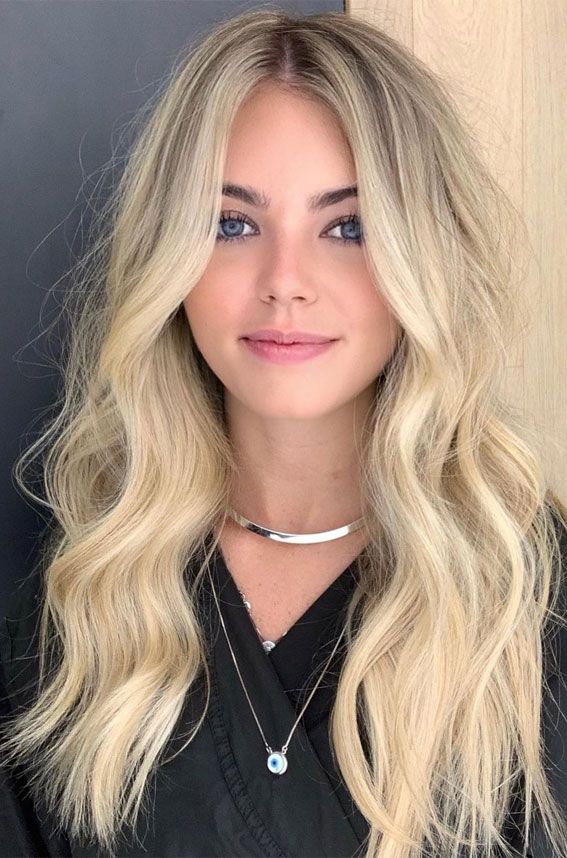 Long golden blonde wavy hair on a brunette