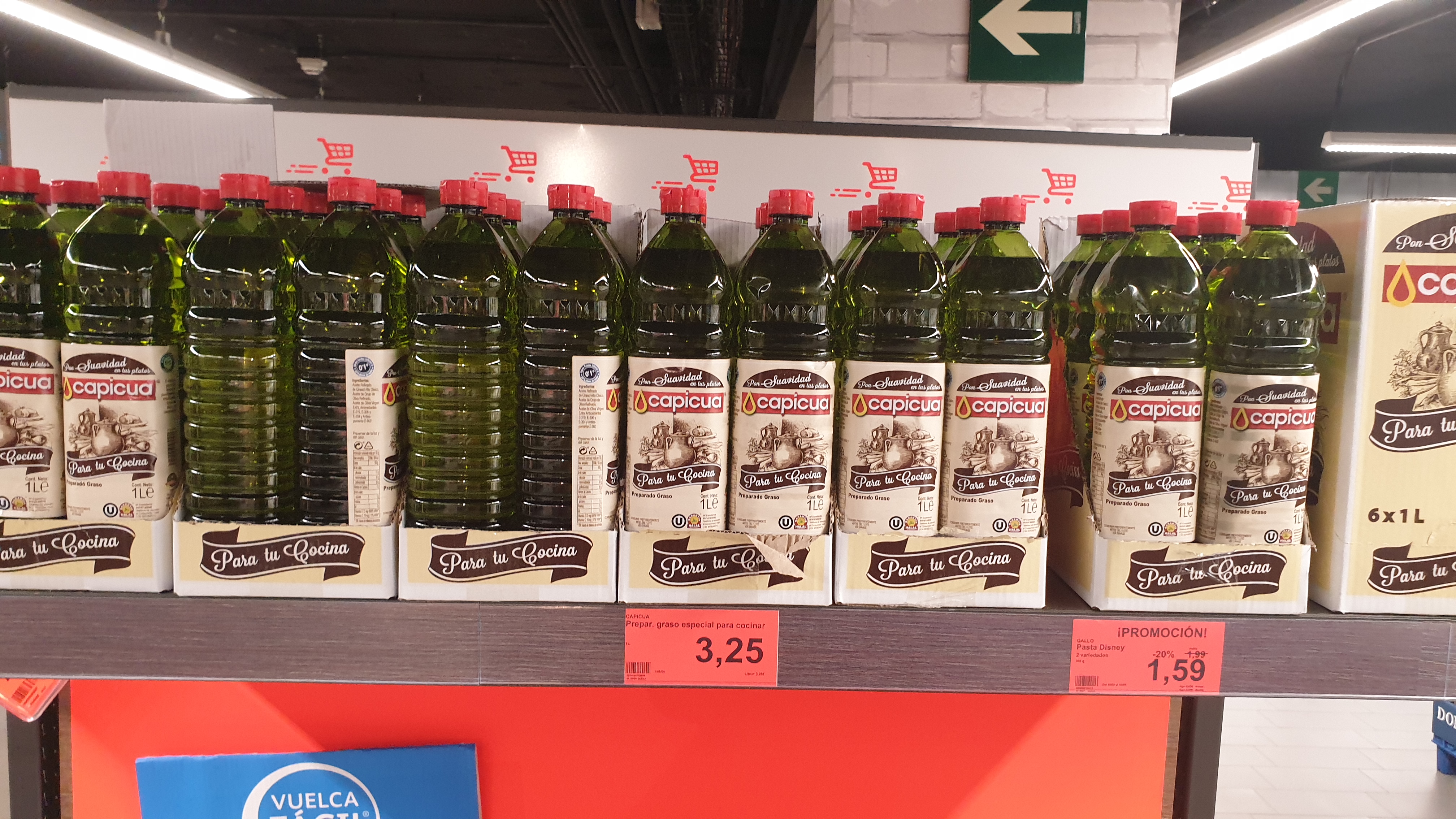 Envase de preparado graso para cocinar en el lineal de un supermercado junto a botellas de aceite de girasol y de aceite de o