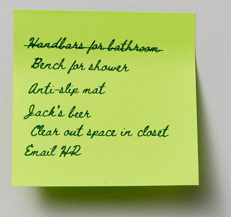 a post it note of a to-do list of things they need to sort otu for Jack to move in including a bench for the shower, email HR and clear out space in the closet. The first item, handlebars for the bathroom as already been crossed off