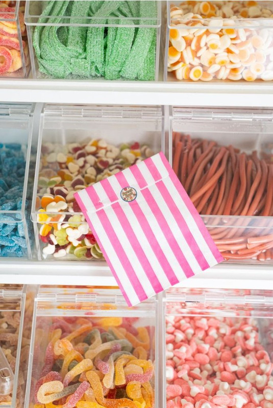 Our signature candy bag resting on a selection of sweets