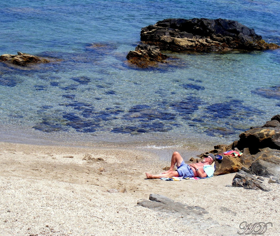 man-sunbathing-beach-cove-HD.jpg