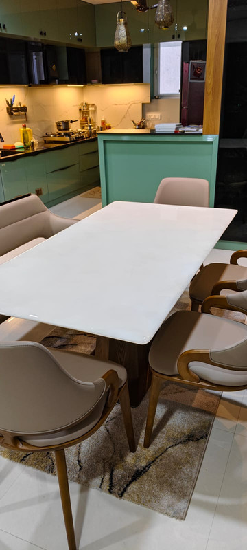 Technician installing countertop protection film in kitchen