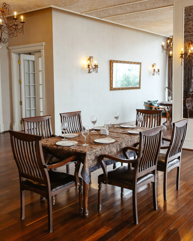 Bohemian Dining Room Design With Rattan Chairs and Dark Wood Table