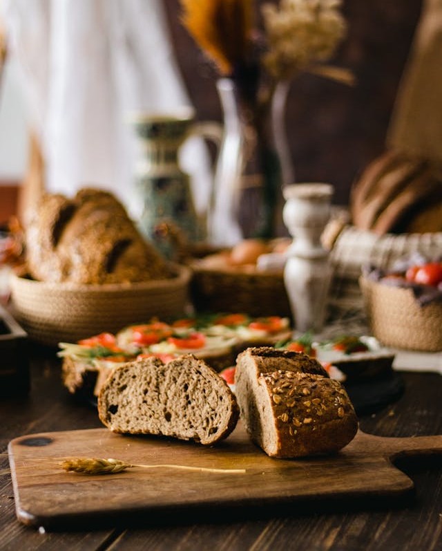 A rustic table spread with various artisanal breads
