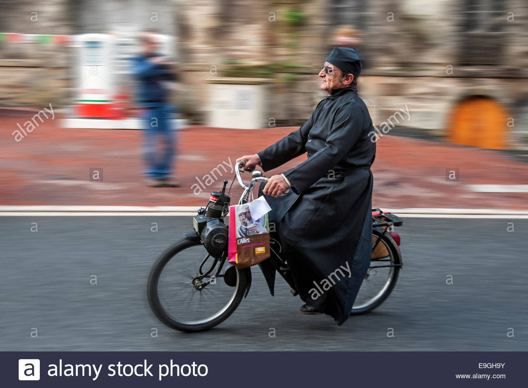 priest-wearing-a-cassock-on-solex-during-the-embouteillage-de-la