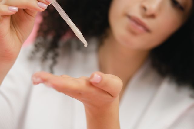 Woman using a hydrating serum with humectants to deeply hydrate, nourish, and heal the skin barrier