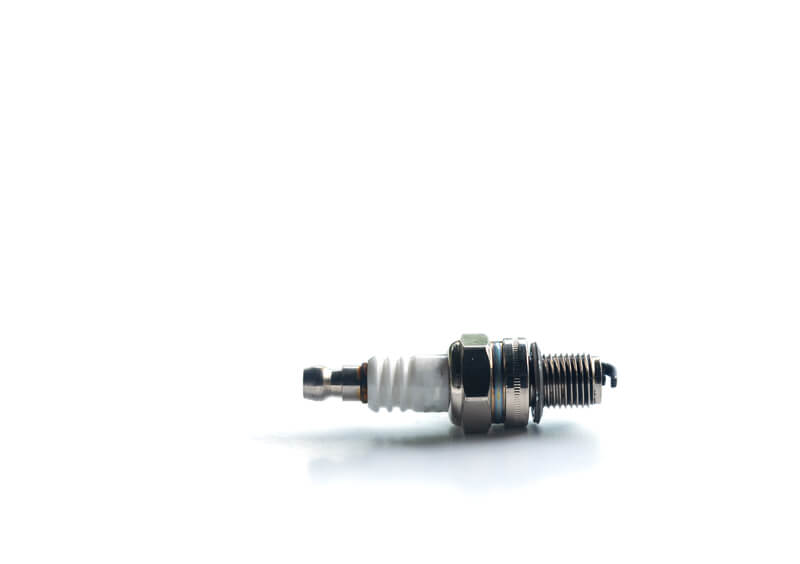 Lawn mower spark plug on white background