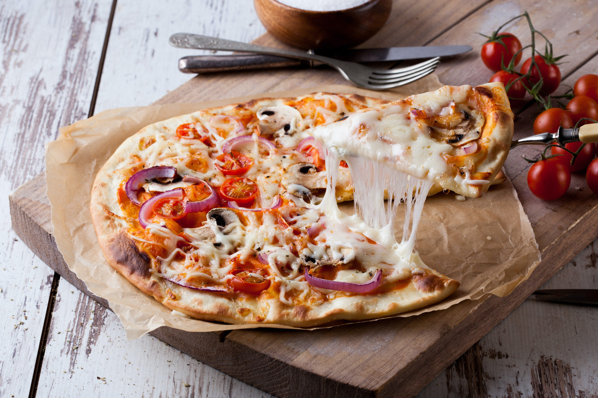 Hand-thrown pizza with stringy mozzarella