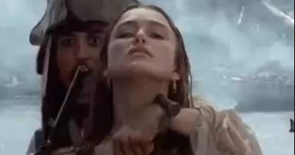 A Hot Nude Girl Posing With Her Boobs And Pussy On Display While A Guy Stands Behind Her With A Gun Pointed.