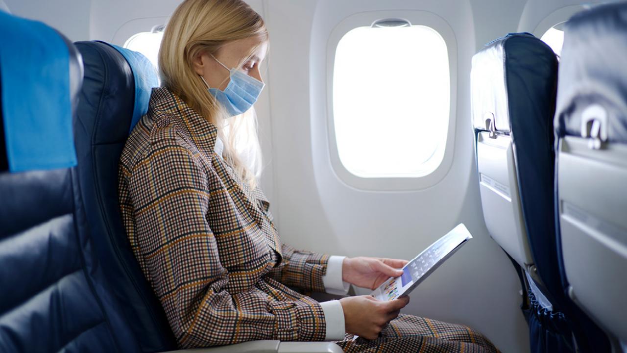 Girl reads magazine from the plane