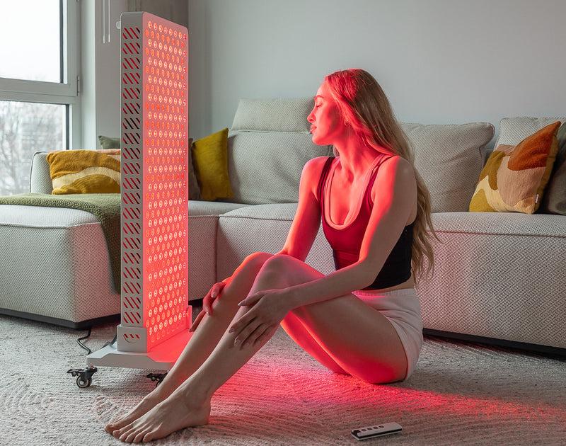 Person using a Mito Red Light therapy panel in a modern home wellness space.