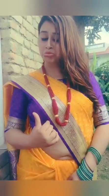 Beautiful Nepali Aunty Sexy open Big Deep Navel in Orange Saree.mp4_snapshot_00.05.209