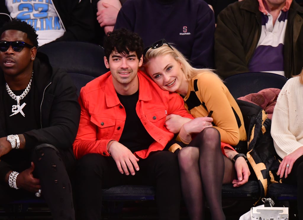 Sophie-Turner-Crossed-Legs-in-Pantyhose-Attend-sacramento-king