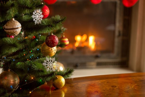 0-Closeup-image-of-golden-baubles-on-Christmas-tree-at-fireplace.jpg