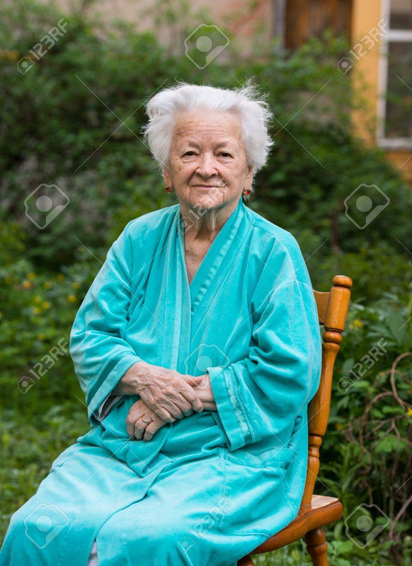 19408157-portrait-of-smiling-old-woman-sitting-on-a-chair.jpg