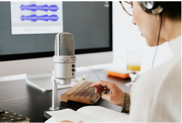 a podcaster taking notes