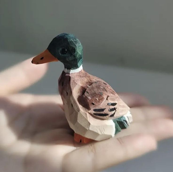A wooden statue of a Mallard duck