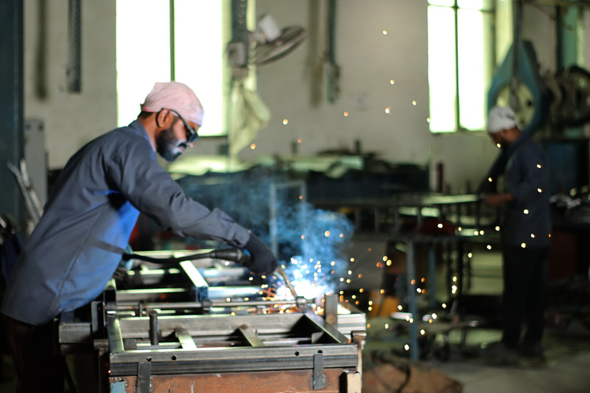 Workers Assembling EV
