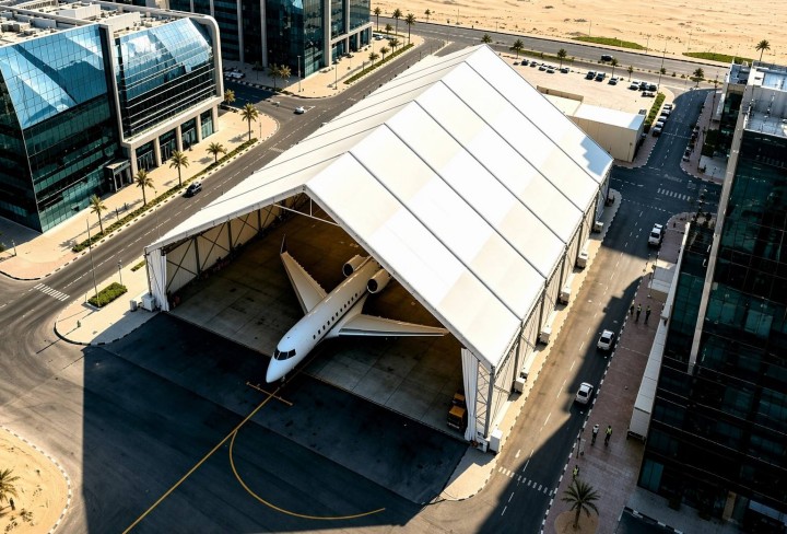 Aircraft hangar tent night view showing illuminated structure