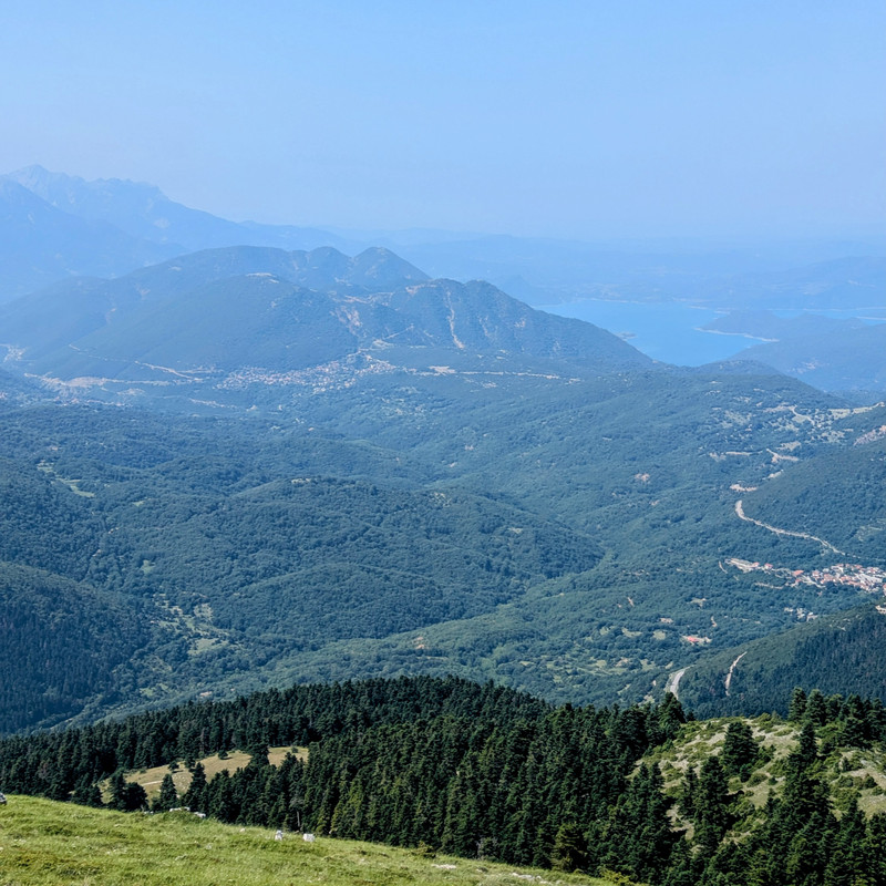 View of a river surrounded by mountains and a couple of villages