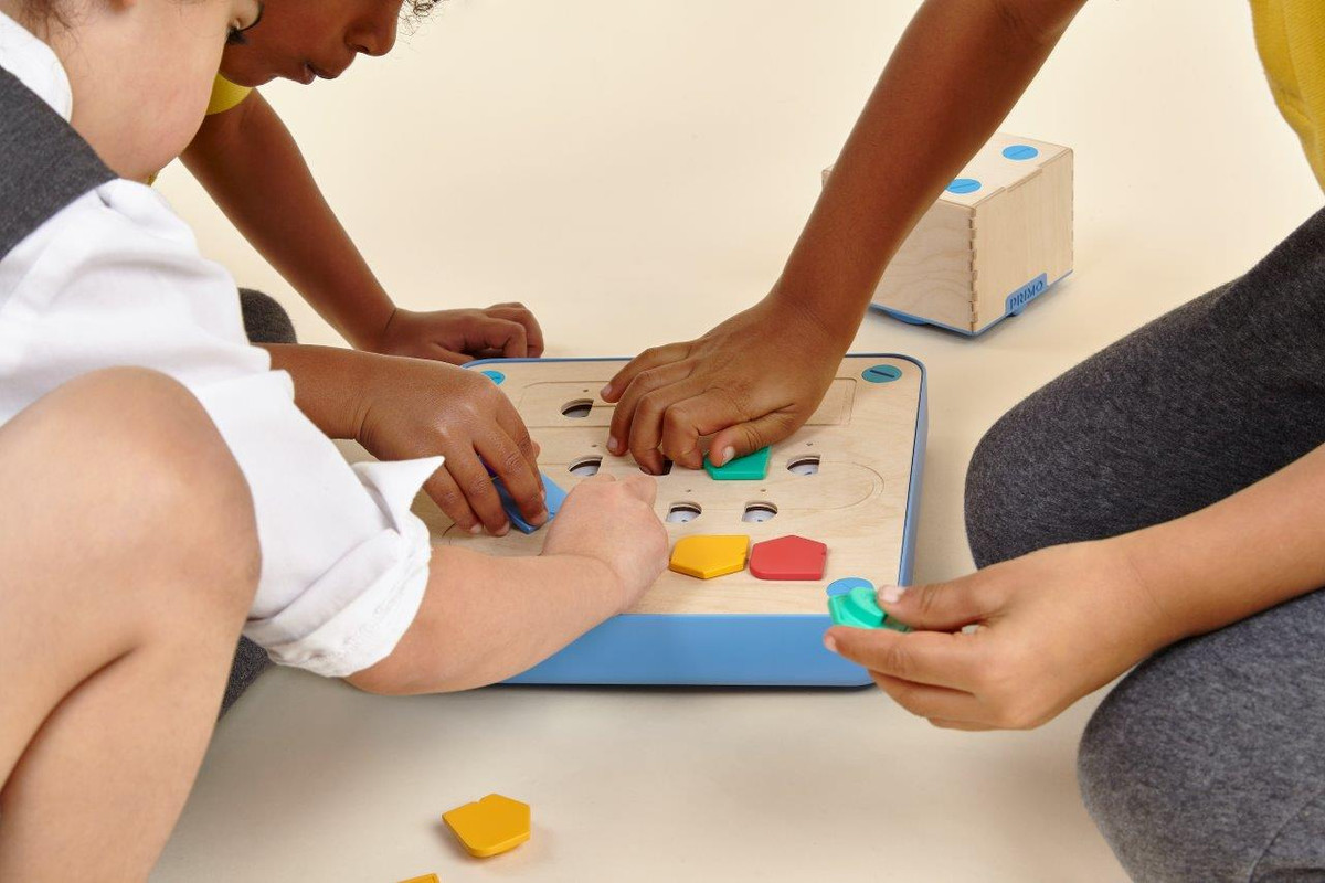 Child interacting with Cubetto