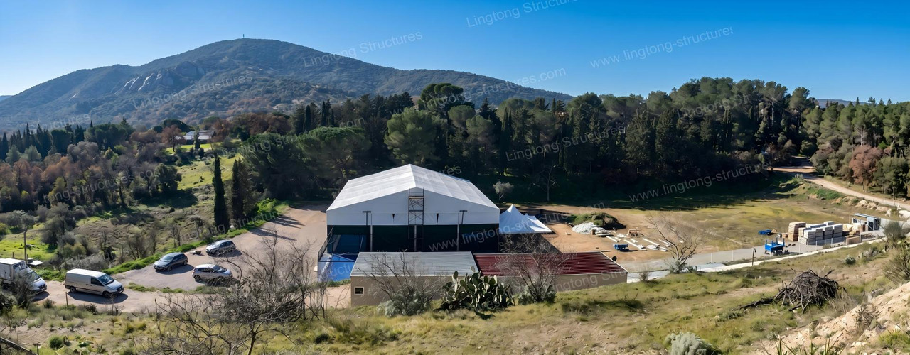 On-site real photos of aluminum modular tennis court tent installation showing clear span interior and frame structure