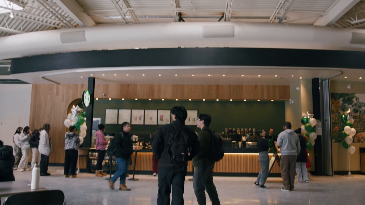 Finished Starbucks cafe with curved bulkhead and wood slat walls on opening day