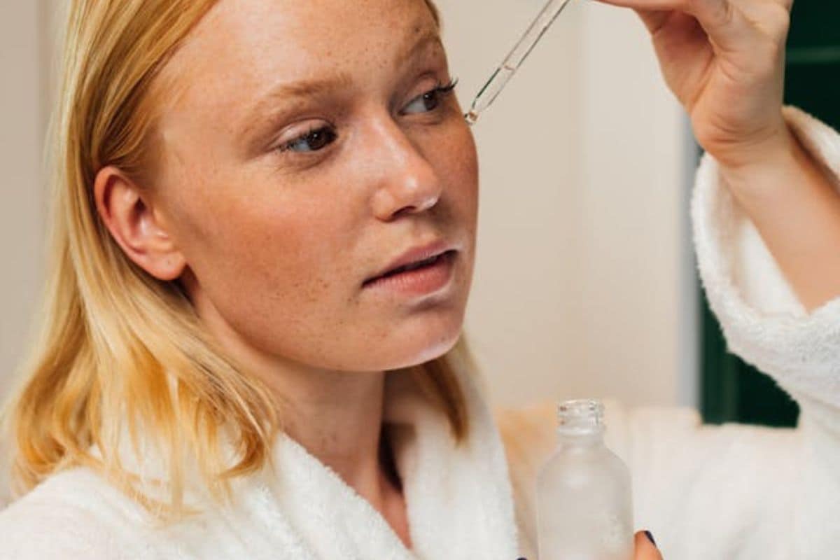 a woman applying active-ingredients based serum after her skin barrier is repaired 