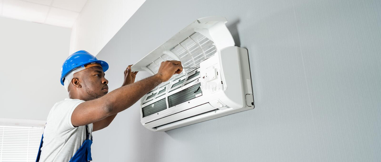 AC technician installing an air conditioning unit