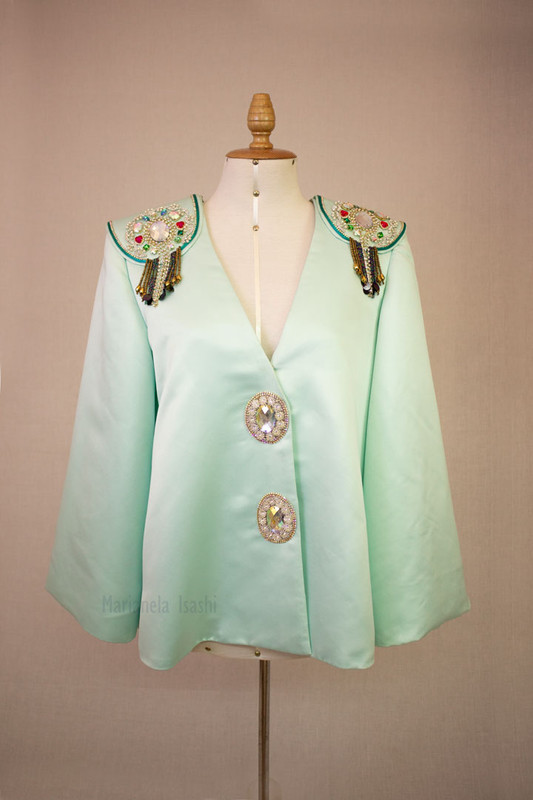 Aqua green blazer with rhinestone embellishments on the shoulders and decorative buttons.