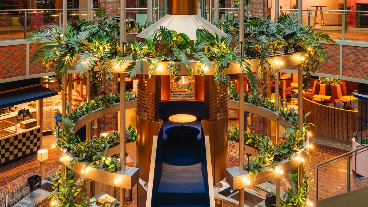 Food court lighting around the central bar and illuminated planting rings at Le big TamTam in Hamburg