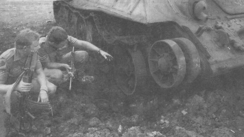 South-African-soldiers-examine-a-T-34-knocked-out-during-Operation-Savannah-in-1976.jpg