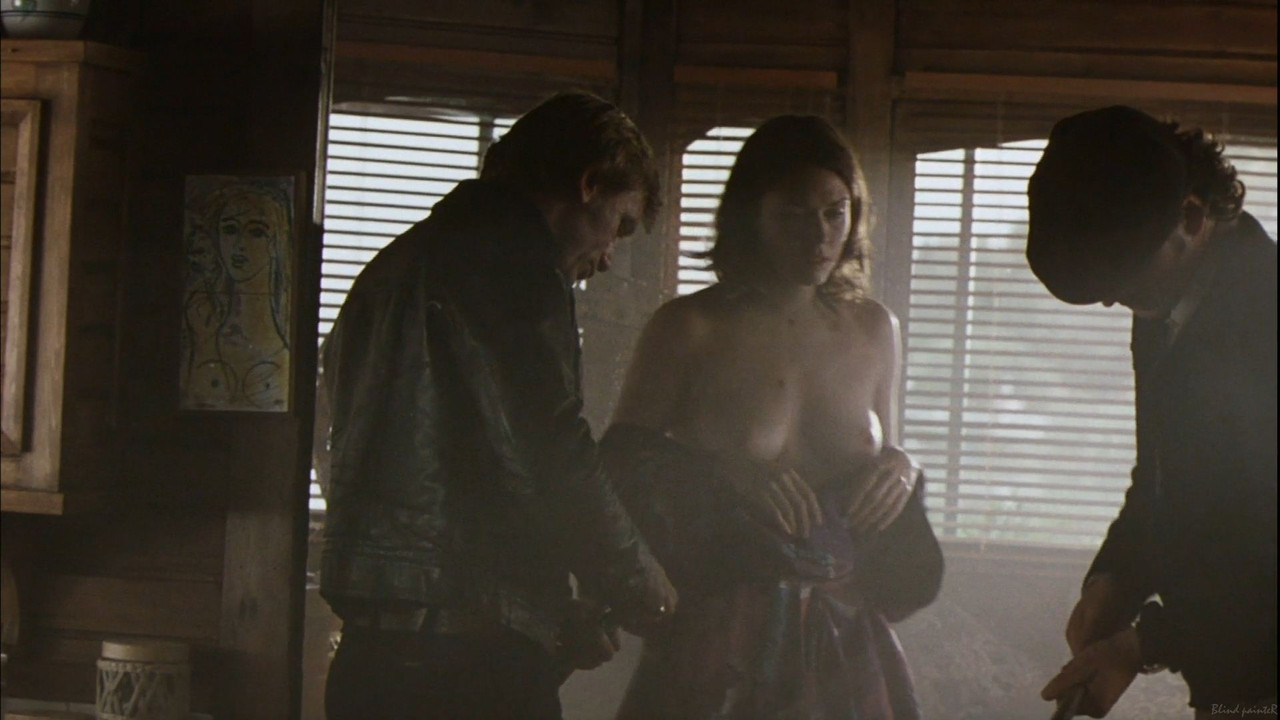 Her silhouette against the dramatic backdrop